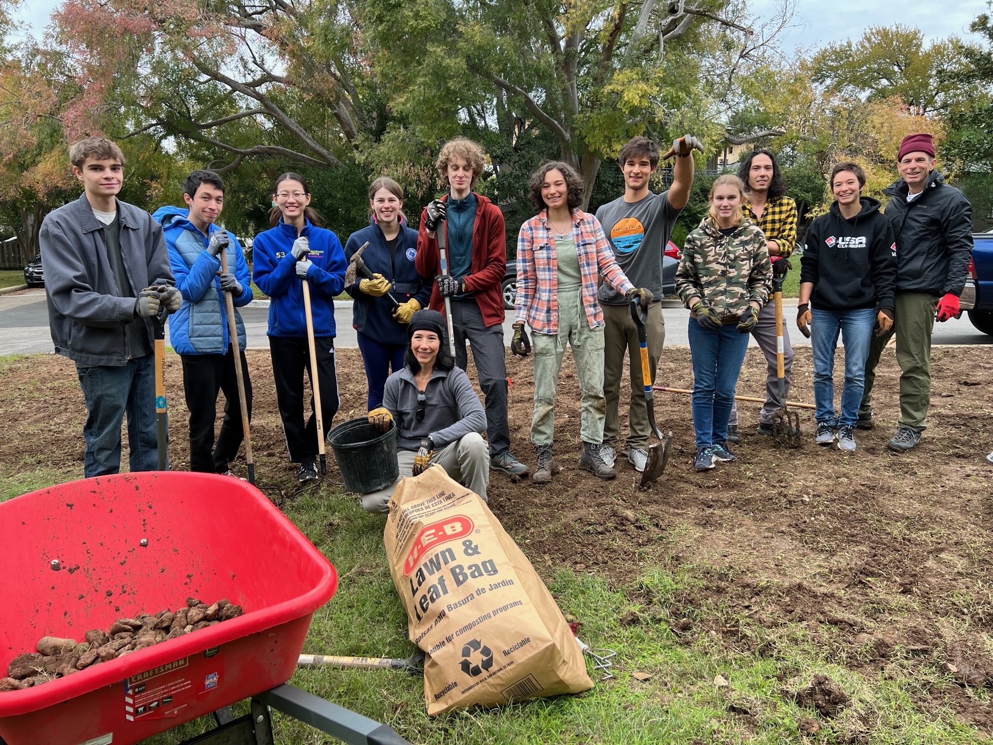 Juliette’s crew, taking a second to pose while planting. Left to right: Flynn Crawford, Patrick Chao, Crystal Ying, Sasha Krigel, Monica Flores (kneeling), James Hodges, Juliette Madere, Alfred Madere, Lucy Collier, Michael Detjen, Maya Madere and Steve Madere. Photo by Karen Kocher