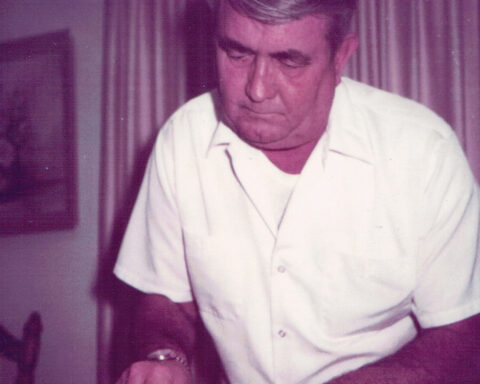 Linda’s father, Clyde, carves a Thanksgiving turkey. Dark meat, please.