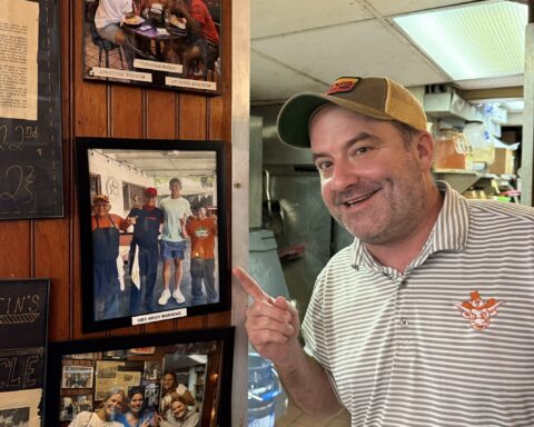 Daniel Young, General Manager, Dirty Martin's Place, points to the photo of Arch Manning.