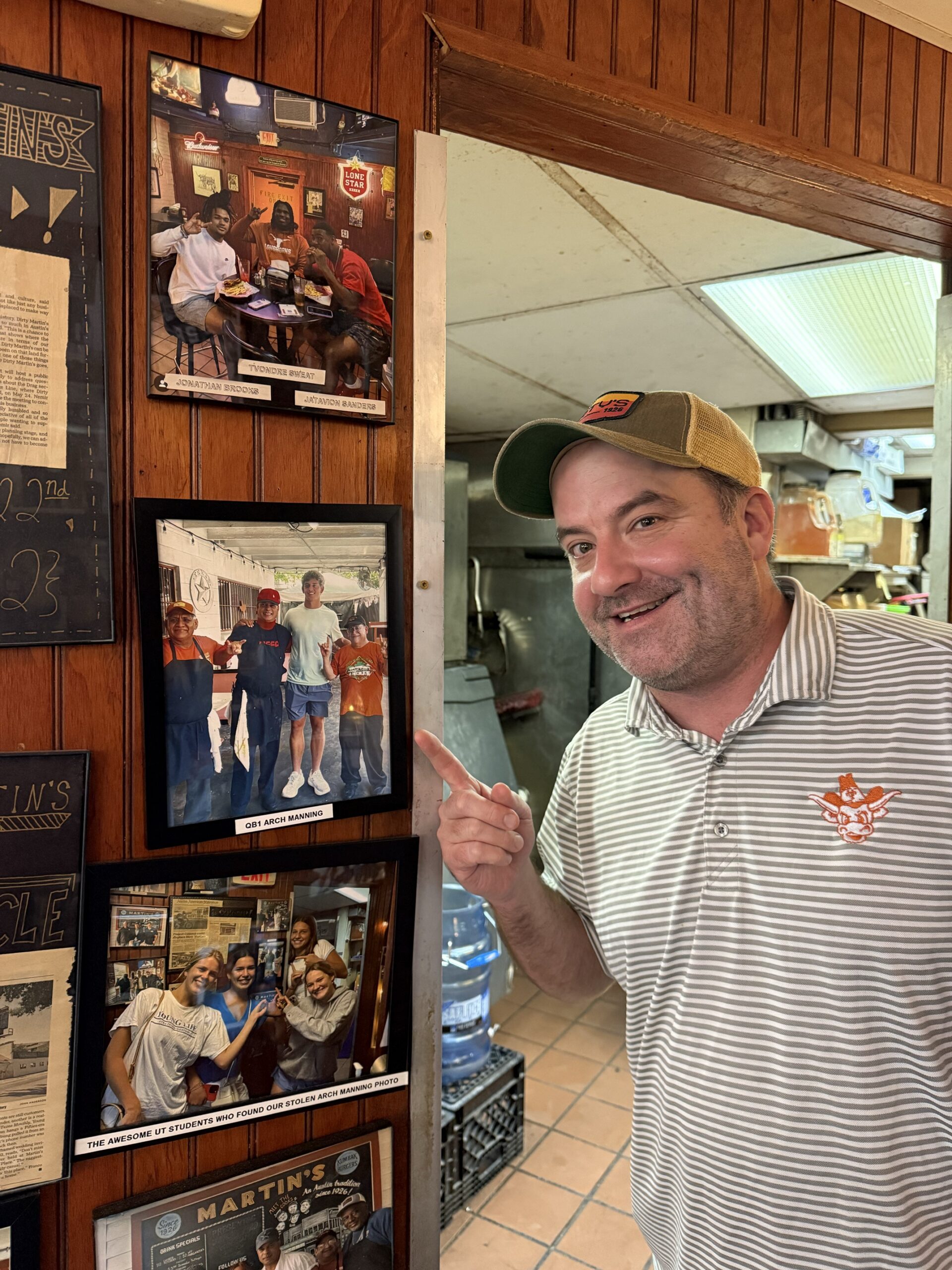 Daniel Young, General Manager, Dirty Martin's Place, points to the photo of Arch Manning.