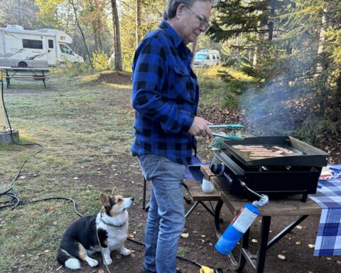 Loretta the Corgi and Mark Hallman monitoring breakfast, Sleeping Giant Provincial Park, Ontario