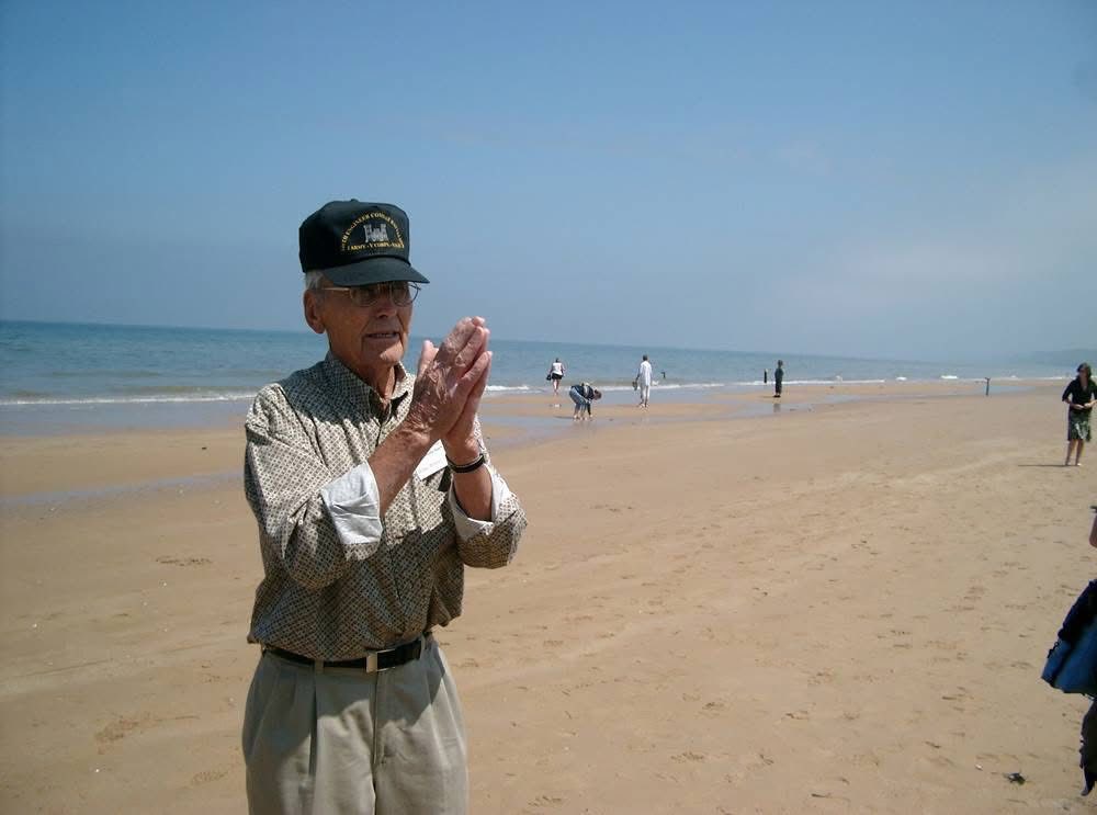 Paul Gray on Omaha Beach in 2004, talking about his experiences on D-Day.