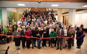 Austin Mayor Kirk Watson cuts the ribbon to open the newly located Austin History Center.