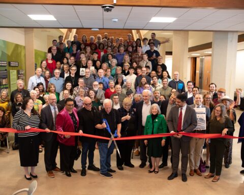 Austin Mayor Kirk Watson cuts the ribbon to open the newly located Austin History Center.