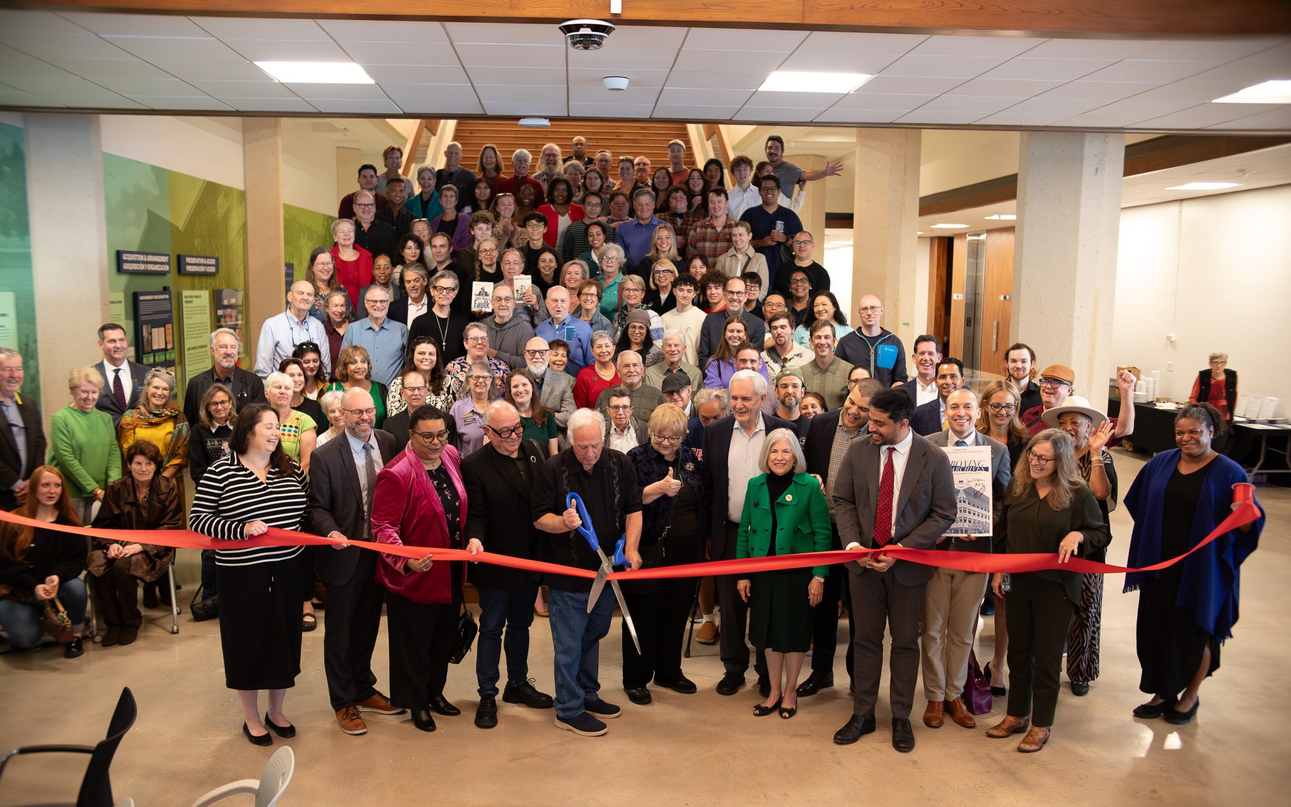 Austin Mayor Kirk Watson cuts the ribbon to open the newly located Austin History Center.