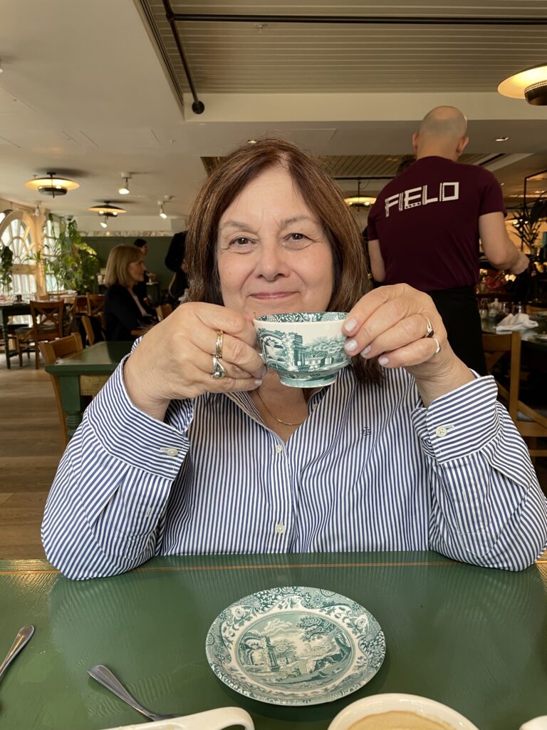 Ann savors a cup of tea while thinking about her next project. This photograph was taken in London while she was having lunch in the restaurant at Harrods.