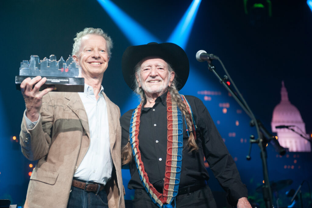 Terry Lickona welcomes Willie Nelson into ACL’s Hall of Fame at the inaugural event in 2014. Photo by Scott Newton. Photo courtesy Austin City Limits/Austin PBS.