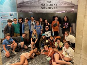 Visiting the National Archives Museum in Washington, D.C. (Standing Back Row, L to R): Alex C., Riji C., Malcolm R., Elijah A., Rishaan M., Jeremy U., Jia S., Eveline N., Sam M., Carina A. (Kneeling/Sitting Middle Row, L to R): Sebastian C., Asher B., Corie H., Nathan U. (blue hat), Brydon D. (holding the "Claim the World for Paragon" Flag), Sonia A. (giving the peace sign), Tenley G., Ella G. (Front Row Lying Down, L to R): Reena D., Violet N., Olivia N. (far right, sitting)