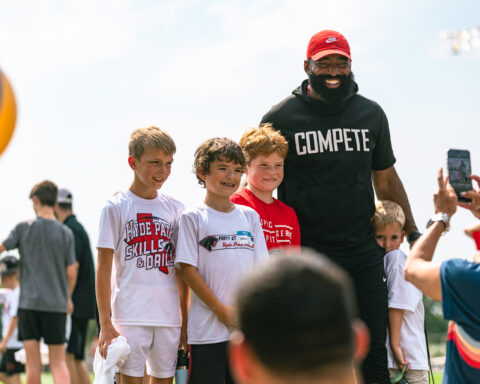 Bennett Nurnberg, Joshua Manning, Everett Weathers with Coach Roby for Skills and Drills Football Clinic