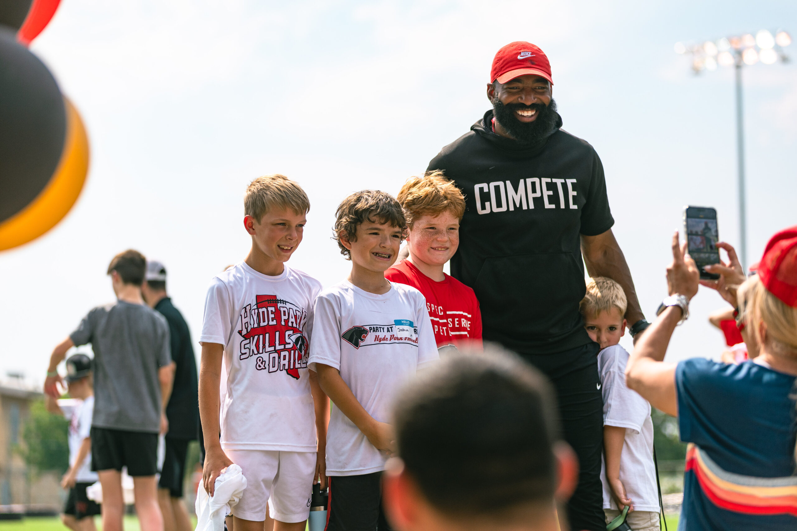 Bennett Nurnberg, Joshua Manning, Everett Weathers with Coach Roby for Skills and Drills Football Clinic
