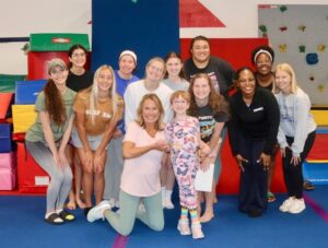 ChampionsTX staff and Cassidy following a ‘Cartwheels for Cassidy’ fundraising event Back row- Coach Marissa Gonzales, Coach Maddie Gilbert, Coach Katherine Nichols, Coach Kaia Brooks, and Sharonna Banks Middle row- Coach Maria Leidenthal, Coach Kahla Archibald, Coach Kaylie Berens, Coach Kaitlyn Herriage, Coach Chelsea Tubonemi, and Coach Laura Coyle Front row- Janet Scott and Cassidy