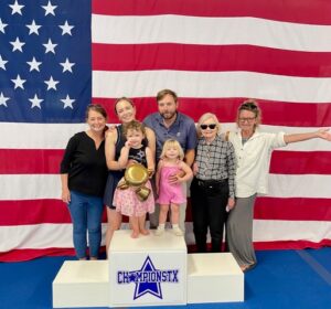 “Decade” Dana Wills (10 years with ChampionsTX) and family Back row- Dana Wills, daughter-in-law Allie Wills, son Austin Wills, mother Virginia Leech, and sister Kelley McGill Front row- granddaughters Charley and Margot