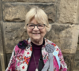 Martha outside the Reception Hall in Galashiels, as a guest at the “Braw Lads and Lassies” Common Riding of 2026, photo by Cyrus Cassells.