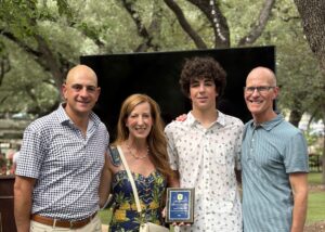 Coach Trey with Price Malone recipient, Judah Schwartz and his parents, Kelly and Offir Schwartz.