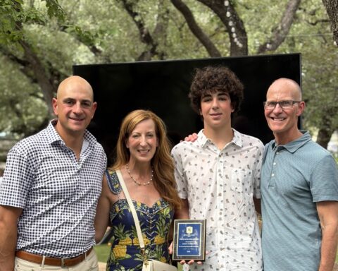 Coach Trey with Price Malone recipient, Judah Schwartz and his parents, Kelly and Offir Schwartz.