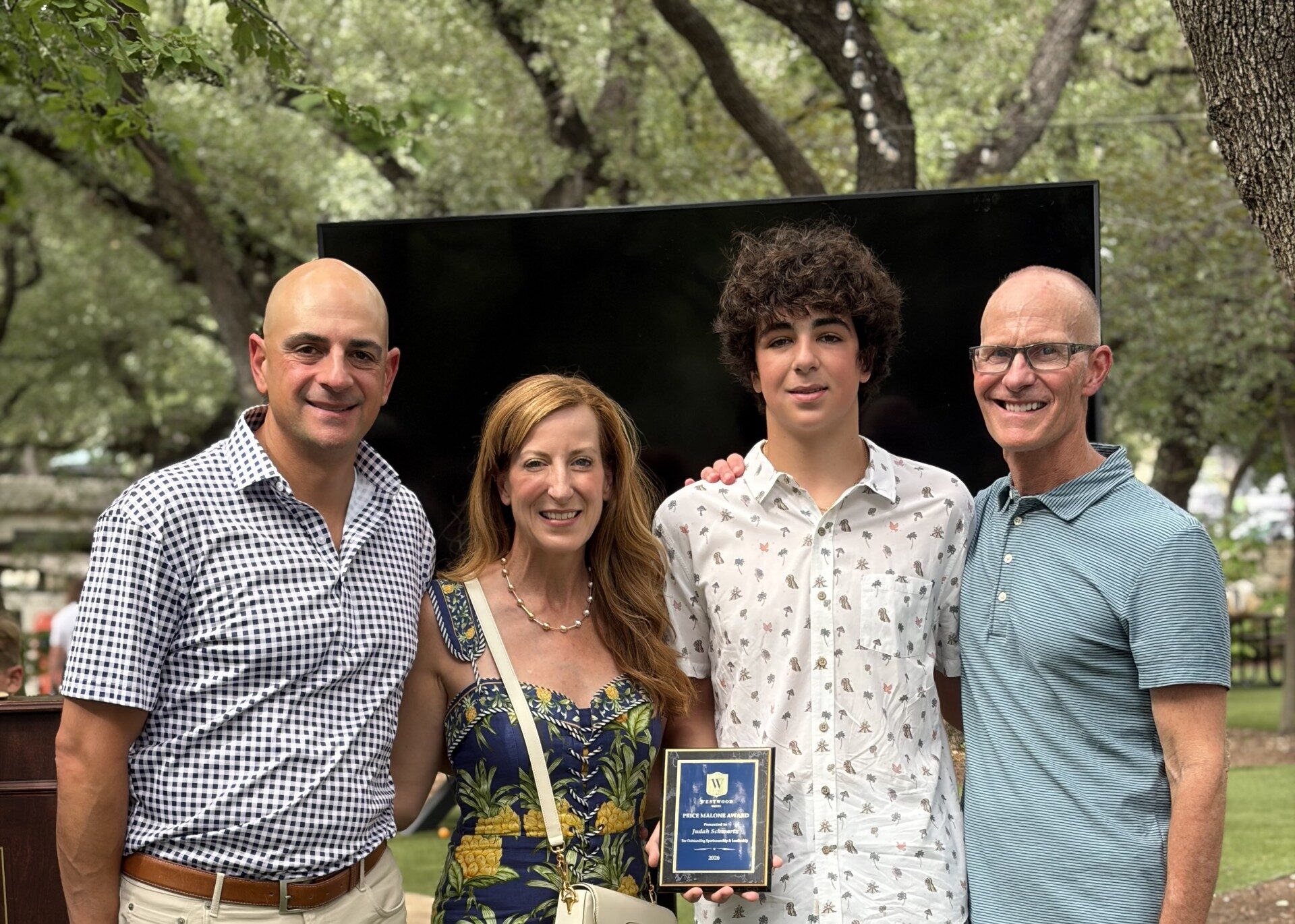 Coach Trey with Price Malone recipient, Judah Schwartz and his parents, Kelly and Offir Schwartz.