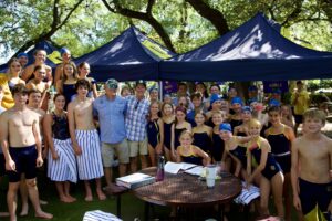 Age 9 and up swimmers with Coach Sean and Coach Trey at the Grand Prix.