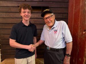 SMPS Junior Chris McGlathery with 102-year-old Westlake resident and World War II veteran pilot Lew Griffith