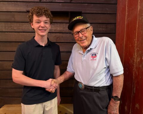 SMPS Junior Chris McGlathery with 102-year-old Westlake resident and World War II veteran pilot Lew Griffith