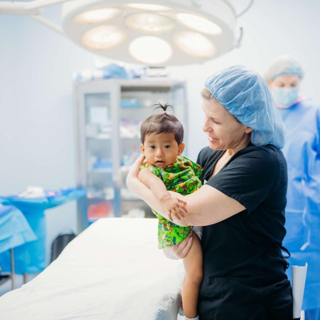 Barbara Powell with an Austin Smiles patient in El Salvador