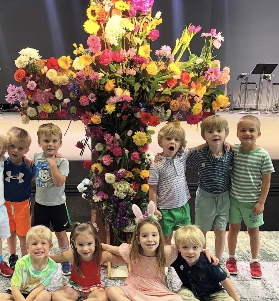 Students at the Casner Easter tradition, which adorns the cross with flowers that the children each bring to school, creating a beautiful symbol of hope, renewal, and faith