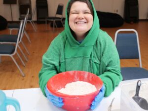 BiG Citizen Emma at the downtown Austin BiG campus getting ready to mix dough to make dog treats available at Tomlinson’s in Austin