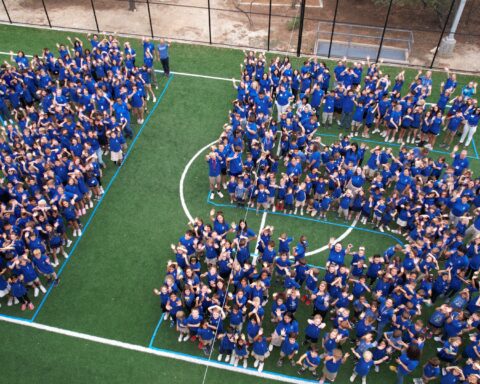 Aerial view of Kindergarten through 9th-grade students forming a 15