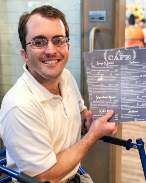 BiG Citizen Bradley ready to greet guests at the BiG Cafe during his shift