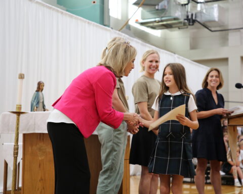 Mrs. Lynch awards certificate to St. Michael’s Prep student at the quarterly Core Values recognition