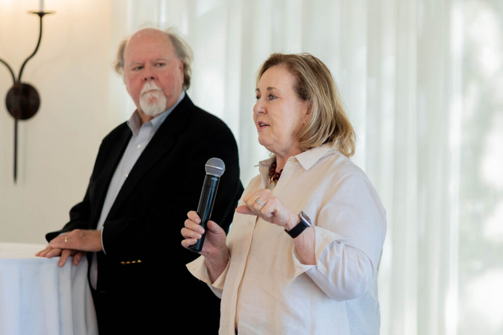 Event MC and Alzheimer’s Texas board member Ed Clements with DKR President Debbie Hanna