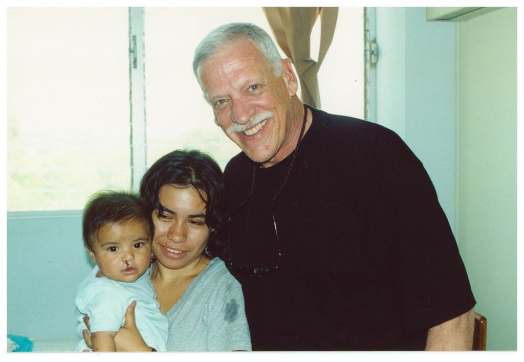 Dr. Rick Parker with Mother and Child on Austin Smiles Mission Trip