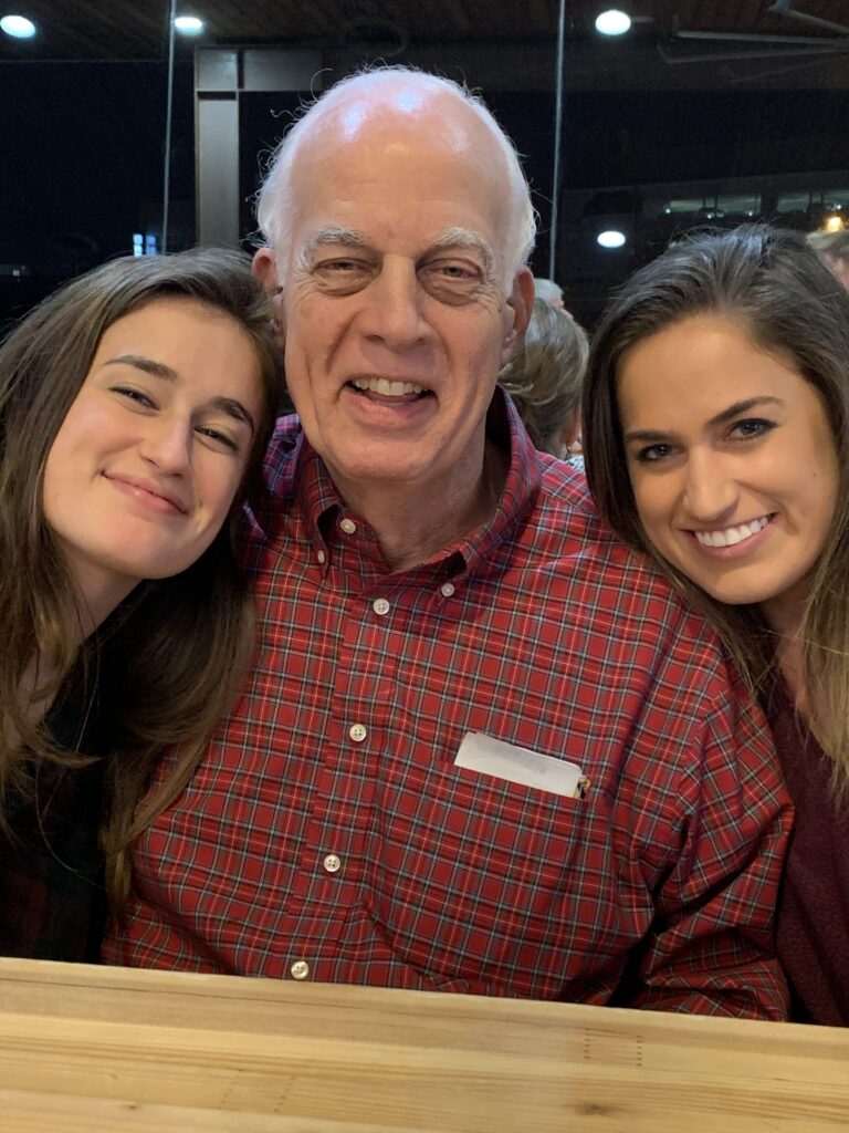 Adopted granddaughters Shelby (left) and Maddy Adams (right) with their grandfather Joe Benson