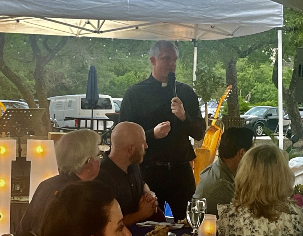 Fr. Jeff Roedel welcoming the crowd to the SUM dinner