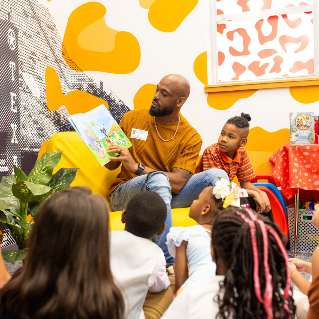 Derrick Johnson reading to students at Barbara Jordan Elementary School (Photo Credit: Giant Noise, Garrett Smith)
