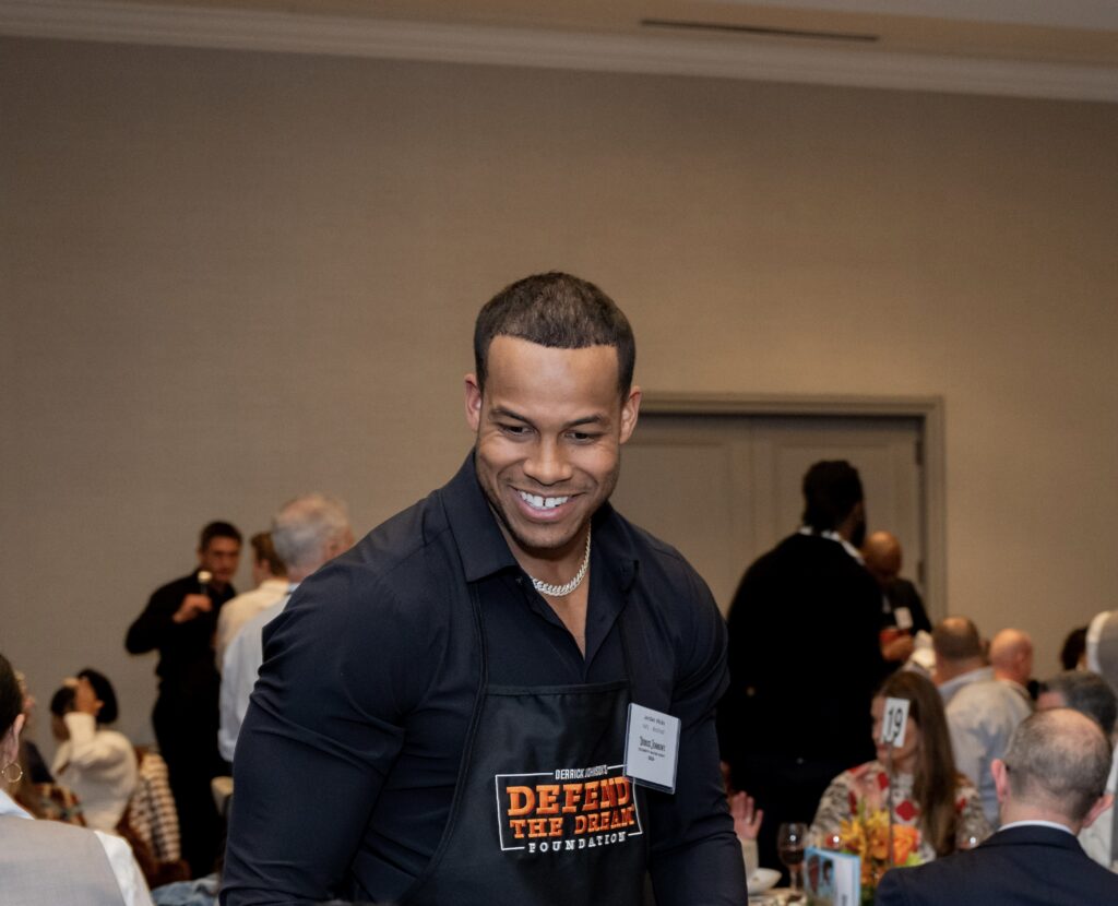 Former NFL player Jordan Hicks serving guests at Celebrity Waiter Night