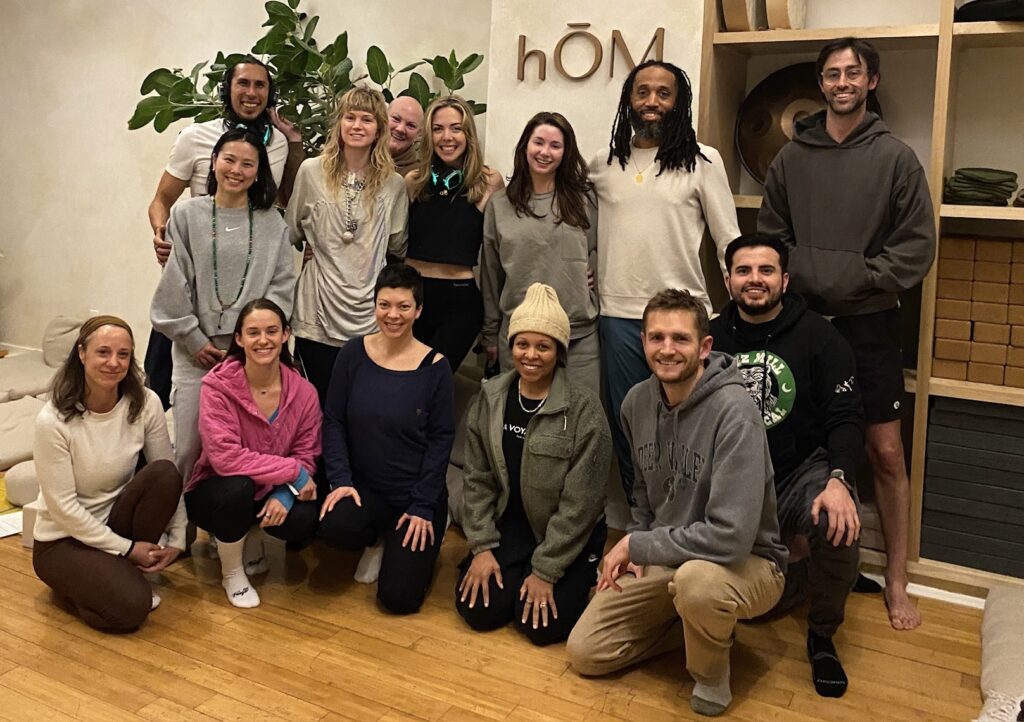 Front row: Debbie Vaughn, Sharon Rahman, Liz Barrow, Jeanne Lyons, Alex Barrow, Daniel Lopez Back row: JJ Ruescas, Goha Kulm, Ellie Bostwick, Christie Cox, Kendall Ivie, Shelby Michael, James Harvey, Ben Johanson at hŌM Yoga Studio