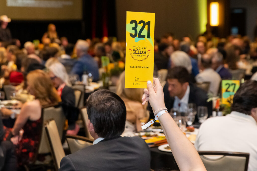 Paddles up during the FORE Kids ATX live auction, which raised over $2 million for Central Texas children