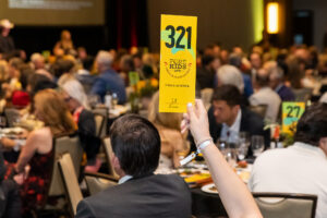 Paddles up during the FORE Kids ATX live auction, which raised over $2 million for Central Texas children