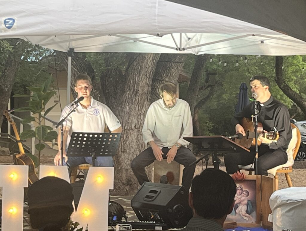 Zeke Pyle, Mark Leatherman, and Fr. Gonzalo Villaseca performing for the crowd