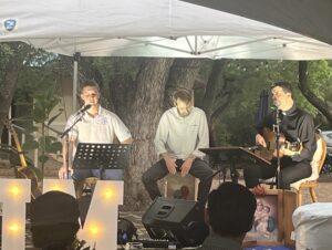 Zeke Pyle, Mark Leatherman, and Fr. Gonzalo Villaseca performing for the crowd