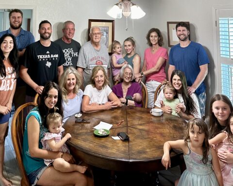 Seated at the table from left to right: granddaughter Deanna Tollinger, holding great-granddaughter Ivory Tollinger, daughter Sarah Boone, daughter Mary Ogborn, wife Sally Busboom, holding great-grandson Scottie Dahse, granddaughter-in-law Casey Boone, holding great-granddaughter Birdie, great- granddaughter Olivia Dahse, holding great-granddaughter Clementine Tollinger, great-granddaughter Adeline Tollinger.