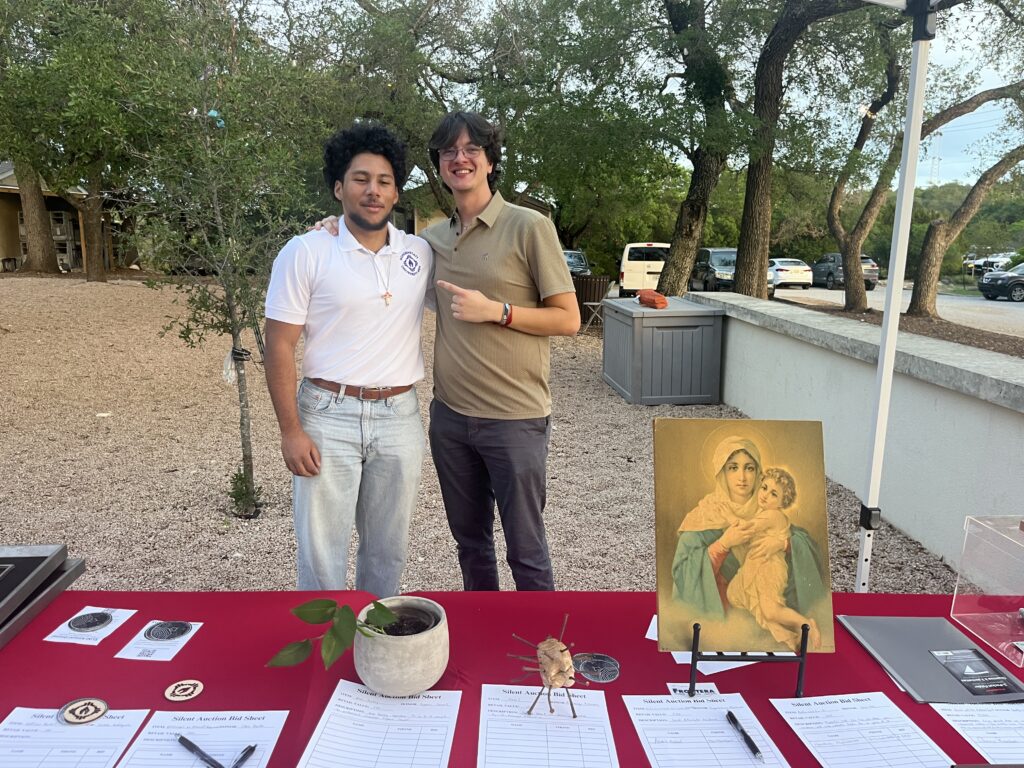 Joshua Sanchez and Thomas Monette working the silent auction table