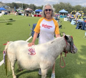 April Baxter from Camp Balcones Springs mingling the field with the Camp mascot