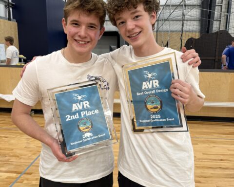 Henry Hubbard and Chris McGlathery holding the team's AVR award plaques