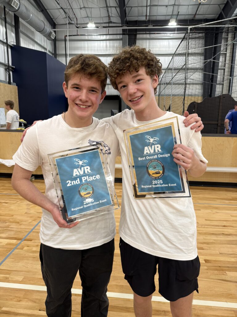 Henry Hubbard and Chris McGlathery holding the team's AVR award plaques