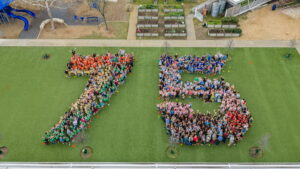 Casis students, faculty and staff, and parents form a giant 75