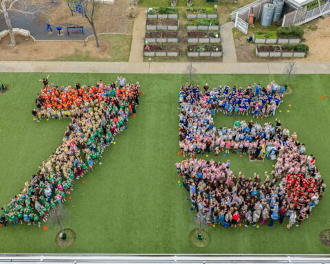 Casis students, faculty and staff, and parents form a giant 75
