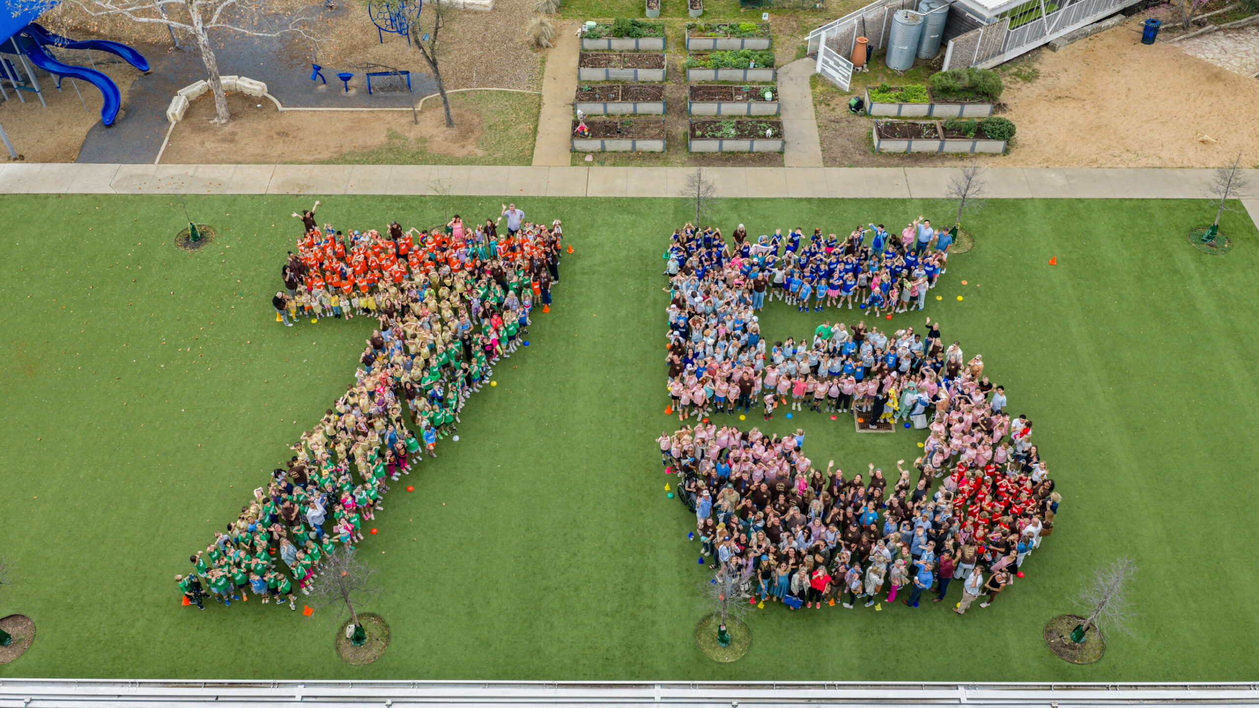 Casis students, faculty and staff, and parents form a giant 75