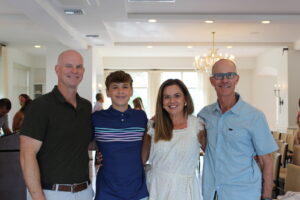 Hayes Newberry with his parents, Kelley and Joe and Coach Trey