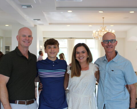 Hayes Newberry with his parents, Kelley and Joe and Coach Trey